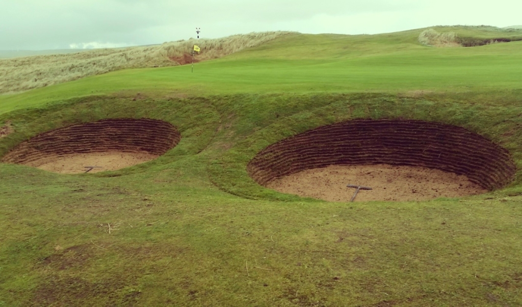 A pair of re-faced bunkers at the left of the 8th green. These should suffer far less from sand blow than they did before.
